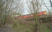 To the north of Crow Road station was one of those peculiar locations where a line passes under itself. In this case a reversing spur which ran from the east side of Crow Road station to alongside the former NB line, (at what later became Hyndland station), was passed underneath by the route to Kelvinside station. The reversing spur gave access to Partick Goods (Caledonian) which was immediately north of Partick Goods (North British). A westbound service pauses at Hyndland station crossing over the trackbed of the former Caley route. View looks north.<br><br>[Ewan Crawford //1999]