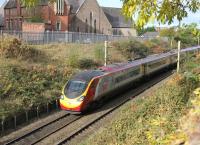 A Virgin Pendolino accelerates northwards having just passed Fylde Junction in Preston on 1st November 2016. The buildings on the left are part of St Walburge's Church, whose tall spire has appeared in many Preston railway pictures down the years. [Ref query 120]  <br><br>[Mark Bartlett 01/11/2016]