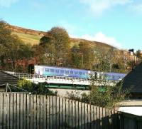 An Edinburgh bound train makes its first crossing of the Gala Water on its way out of Galashiels on 10 November 2016. View is north east from Wheatlands Road. <br><br>[John Furnevel 10/11/2016]