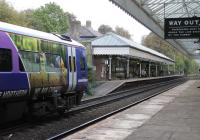 The eastbound platform at Hebden Bridge, with its plethora of traditional signs, seen from the staggered westbound side. Northern 158842 calls on a service heading for Leeds on 21st October 2016<br><br>[Mark Bartlett 21/10/2016]