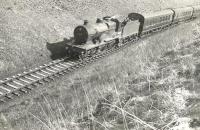 2P 4-4-0 40574 takes a train through the cutting near Hollybush on 28 March 1959 on its way from Dalmellington to Ayr.<br><br>[G H Robin collection by courtesy of the Mitchell Library, Glasgow 28/03/1959]