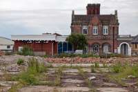 From the late 1970s onwards, the former Maldon East station was largely hidden from view by the large industrial units that were built around it. By 2016, these units had served their time and been demolished, such that the station and its notable architecture stood revealed once more. All rail traffic had ceased in April 1966.<br><br>[Mark Dufton 13/07/2016]