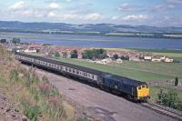 January 2016 marked the 50th anniversary of a major rock fall at Clatchard Craig Newburgh which blocked the Ladybank - Bridge of Earn route as a through line until re-opening on 16th January 1967.  During this time Newburgh goods depot was served by a daily shunt from Perth and a run round loop was provided at Clatchard to enable ballast trains access.  <br>
<br>
25008 passes the site of the rockfall on 29th July 1978 with a Perth - Edinburgh service.<br><br>[Graeme Blair 29/07/1978]