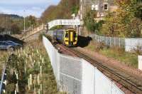 A Tweedbank bound DMU passes below the pedestrian footbridge on Low Buckholmside on 10 November 2016 as it approaches Galashiels station [see image 43490].<br><br>[John Furnevel 10/11/2016]