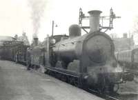 A pair of 1890s veterans waiting to take a Lockerbie train out of Dumfries in April 1949. Caley 'Jumbo' 57409 is the leading locomotive, with Webb LNWR 2-4-2T 46635 behind. Both were withdrawn from Dumfries shed early the following year.<br><br>[G H Robin collection by courtesy of the Mitchell Library, Glasgow 18/04/1949]