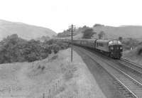 A 'Peak' hauled Anglo-Scottish service southbound at Ardoch, midway between Sanquhar and Carronbridge, in the summer of 1961, with the River Nith off to the left. The train is the 1600 Glasgow St Enoch – Leeds City and is displaying an incorrect reporting code, which should read 1N63. [Ref query 165]  <br><br>[G H Robin collection by courtesy of the Mitchell Library, Glasgow 15/07/1961]