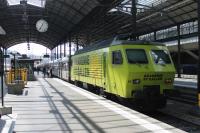 Sudostbahn (Swiss South Eastern Railways) electric locomotive 018, in advertising livery, is on the rear of a train for St. Gallen at the main station in Lucerne in June 2016. A sister loco in black livery was on the front of the train. These loco hauled services are scheduled to be replaced by new Stadler FLIRT EMUs.<br><br>[Mark Bartlett 29/06/2016]