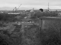 Looking north from the Station Road bridge in 1987 along the course of a recently lifted part of the dock railway system. This was the original dock line later supplemented on a grand scale as further larger docks opened to the east.<br><br>[Bill Roberton //1987]