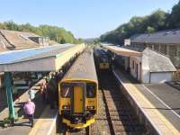 Community Rail Train at Okehampton in October 2015. The large refurbished former goods shed on the far right is now a YHA youth hostel.<br><br>[Ian Dinmore 02/10/2015]