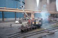 Rail mounted crane delivering wheel sets to the locomotive shed at Ravenscraig in 1987. Behind and to the left is the larger of the two distinctive gasholders which dominated the area.<br><br>[Ewan Crawford //1987]