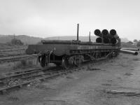 A train of bogie bolsters with pipes on board in the sidings at Burntisland Docks  in 1987.  Possibly the last rail traffic there.<br><br>[Bill Roberton //1987]