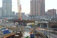 View south from near Salford Central towards Ordsall on 15 December 2016, with Trinity Way dual carriageway snaking through the Ordsall Chord worksite. Sections of the new bridge that had been stored in the yard in the foreground during October [see image 56746] are now in place in the centre of the photograph. Beyond is a 6 car Class 185 heading west towards Ordsall Junction.<br><br>[John McIntyre 15/12/2016]