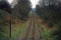 This stretch of track is part of what remained of the Watford to Rickmansworth (Church Street) line on 27th December 1975. The view is eastwards towards Croxley junction from an overbridge near Vicarage Road in Watford. The line was in sporadic use at the time for fuel oil deliveries to Croxley paper mill. The mill closed in 1980 and the trackbed now forms the Ebury Way. Early in its existence, there was a plan to connect this line to Edgware via Bushey and Elstree.<br><br>[Mark Dufton 27/12/1975]