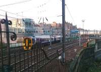 A weak sunrise over the east end of Waverley as the 0855 Edinburgh - Tweedbank crosses the bridge over Calton Road shortly after leaving platform 7 on Saturday 17 December 2016.<br><br>[Andy Furnevel 17/12/2016]