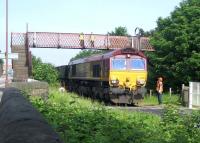 A trainload of imported Russian coal from Leith Docks, destined for Cockenzie power station, leaving Leith South yard on a sunny morning in June 2006. EWS 66205 is in the process of manoeuvring its train east over the manually operated Seafield level crossing. The A199 Seafield Road runs past on the left.<br><br>[John Furnevel 07/06/2006]