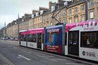 Tram 261, carrying an advert for free Hogmanay services, heads along York Place bound for the airport on 19 December.<br><br>[Bill Roberton 19/12/2016]