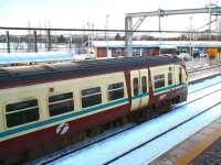 An SPT liveried class 334 EMU calls at Bathgate on a winter's day in December 2010 with an Edinburgh Waverley - Helensburgh Central train. The modern building in the background is part of ScotRail's recently opened Bathgate depot.<br><br>[John Furnevel 14/12/2010]