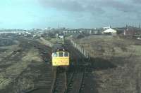 A Class 25 shunts the Coal Concentration Depot at Southport in February 1980 [See image 45006]. Above the loco the old steam depot, by now <I>Steamport Southport</I> can be seen and to the right of that the old Southport Central station, former terminus of the West Lancashire Railway from Preston. This had only been open to passengers for nineteen years closing in 1901 but continued as Kensington Road Goods until 1973. The life and times of Southport Central is comprehensively covered on the excellent Disused Stations website. It was finally demolished soon after this photo was taken.<br><br>[Mark Bartlett /02/1980]