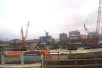 Looking north from a train travelling on the Castlefield Viaduct on 15 December 2016, the start of the new bridge over the River Irwell can be seen above the orange and white barriers on the left. <br><br>[John McIntyre 15/12/2016]