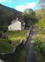 This crossing keeper's cottage at Llangeinor on the Blaengarw branch seems to have been extended in most available directions. Photographed from the bridge which replaced the crossing - view looks North.<br><br>[Ken Strachan 22/10/2016]