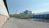 A 303 passes Yorkhill Quay West Basin in 1991. The view looks north away from the Clyde. The lines in the cobbles here ran east to Stobcross and Kelvinhaugh where there were connections into both the NBR and Caley systems.<br>
<br>
This dock was filled in during preparations for the new Glasgow Transport Museum. Surely an odd choice for a city famed for its shipbuilding.<br><br>[Ewan Crawford //1991]