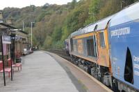 Biomass empties head for Liverpool passing south through Todmorden on 21st October 2016. The train has just left the viaduct to the north of the station [See image 57131]. Motive power is GBRf 66708 <I>Jayne</I>, seen from the Manchester platform.<br><br>[Mark Bartlett 21/10/2016]