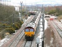 A cold March day in 2005 sees EWS 66206 held at signals at the north end of Millerhill yard with a train of coal empties for Ravenstruther. The delay is due to a 158 service from Bathgate about to arrive at Newcraighall station behind the camera. The empty passenger train will shortly run into the turnback siding on the right [see image 2874].<br><br>[John Furnevel 22/03/2005]