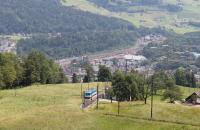 Krabel station and loop, with a train waiting to cross, seen from a descending car on the Rigi Bahn rack railway. Below Krabel station the freight yards at Arth Goldau on the SBB Gotthard line can be seen. Arth Goldau station is also the terminus of this branch of the Rigi Bahn, the other being Vitznau on Lake Lucerne.   <br><br>[Mark Bartlett 27/06/2016]