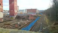 Remains of the old Edinburgh Corporation tram depot at Shrubhill on 28 December 2016 [see image 51274]. View south east along the Powderhall branch with the start of the loop visible below. In the distance the platform remains of Leith Walk station can just be seen.<br><br>[Andy Furnevel 28/12/2016]