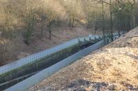 At the western end of Chorley Tunnel there is a steep sided cutting and to help keep the cutting sides apart there are a series of arches. On 26 December 2016 with the vegetation cut back in readiness for electrification, it is now possible to see some of the arches. The arches were carefully removed in 2015 for a steel arch to be put in place and the stone arch then placed on top.<br><br>[John McIntyre 26/12/2016]