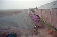 View west from the former bridge over the railway at Kelso station in 1998. The new alignment of the A698 used the former railway. The former eastbound platform extended beyond the station (behind) alongside the building to the right.<br><br>[Ewan Crawford //1998]