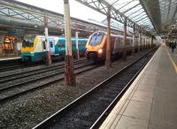 A down Voyager passes an EMU at Crewe in October 2016. <br><br>[Ken Strachan 07/10/2016]