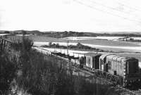 Demolition train on the Kelso branch on the section between Rutherford and Maxton in October 1969. The locomotive is Class 10 D3638, withdrawn by BR and subsequently leased to the contractor for use in connection with tracklifting operations on the branch. [See image 30192] <br><br>[Dougie Squance (Courtesy Bruce McCartney) 06/10/1969]