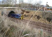 ScotRail 158724 about to run through the site of Tynehead station as it approaches the half way stage on its journey from Waverley to Tweedbank on 27 December 2016. The old station buildings, long converted for private residential use, stand at the top of the cutting on the east side of the line. [See image 24391]<br><br>[John Furnevel 27/12/2016]