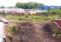 The remains of Rome Street Junction in May 2002, some nineteen years after damage to the bridge over the River Caldew had resulted in final closure of the Carlisle goods lines [see image 5732]. View is south east from Rome Street Bridge. The routes to London Road and Upperby are to the left, with Forks Junction and Currock to the right. On this particular Sunday the surviving leg of the former triangle of lines is occupied by an eastbound engineer's train hauled by EWS 37668. <br><br>[John Furnevel 11/05/2002]