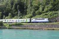 Veteran electric loco 420501, in BLS AG livery, propels a regional passenger service for Zweisimmen alongside the River Aare. The train has just left Interlaken Ost and is negotiating the busy single track section between there and Interlaken West. BLS, SBB and DB services all use this line.<br><br>[Mark Bartlett 20/06/2016]