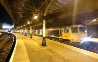 Aberdeen station on 10 January 2017. The Caledonian Sleeper to London Euston awaits its departure time behind 66736 <I>Wolverhampton Wanderers</I> doing the hard work and 73936 taking it easy. On the adjoining platform is 170416 with the 21:05 to Edinburgh Waverley.<br><br>[Alan Cormack 10/01/2017]