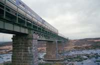 A southbound sprinter passes over Garbh Ghaoir Viaduct, south of Rannoch, in this south facing view.<br><br>[Ewan Crawford //1997]