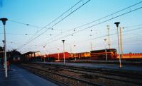 The last rays of the setting sun highlight a variety of rolling stock in the station yard at Tarragona, an historic Catalan city. In this view are various multiple units and a diesel loco of Class 321 in green with yellow stripes.<br><br>[Charlie Niven 24/09/1988]