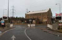 Built by the Midland Railway to provide power for the electrified railway to Morecambe and Lancaster, this is the first <I>Heysham Power Station</I>. Following closure, removal of the generating equipment and some rebuilding it became a workshop for the port, a role it continues to perform today. Seen from the ferry terminal road in January 2017, the railway in the foreground is the short branch to the nuclear power stations. <br><br>[Mark Bartlett 10/01/2017]