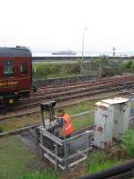 The guard of the evening Jacobite locks the ground frame prior to departure from Mallaig on 10th June 2016.<br><br>[David Spaven 10/06/2016]