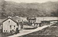 Whistlefield station (built to serve Portincaple on the shore of Loch Long) the Whistlefield Store (now the 'Green Kettle Inn') and stationmaster's cottage. The narrow road bridge to the right will be familiar to many.<br><br>[Ewan Crawford Collection //]