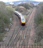 A Virgin Voyager off the WCML via Carstairs joins the Edinburgh 'sub' at Craiglockhart Junction on Sunday 2 April 2006, having left its normal route at Slateford. The weekend diversion was due to engineering works on the E&G just outside Haymarket station. All trains to and from the west and Waverley were being diverted via Niddrie and Portobello. The Voyager is about to pass below the Union Canal.<br><br>[John Furnevel 02/04/2006]