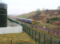 The 4-car 0945 Tweedbank - Edinburgh Waverley, photographed shortly after leaving Shawfair on 22 January 2017 in light rain. The train is passing the Biogen anaerobic digestion facility at Millerhill heading for its next stop at Newcraighall. At this point the train has covered around half of the one mile distance between the two stations. <br><br>[John Furnevel 22/01/2017]