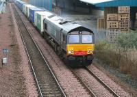 A container train accelerates south west away from Grangemouth towards Falkirk in September 2006. The locomotive is DRS 66408 and the working is the the 0954 Grangemouth WHM - Aberdeen Guild Street [see image 12394].<br><br>[John Furnevel /09/2006]