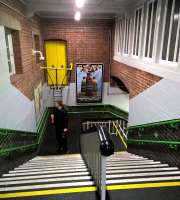 Amazing what a lick of paint can do. The footbridge over the platforms at Nuneaton [see image 38355] has recently been redecorated. The gent ascending seems to be distracted by the advertisement for new housing, which happens to feature an attractive young lady - no, perish the thought... [Ref query 631]<br><br>[Ken Strachan 01/12/2016]