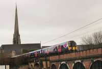 St. Walburge's Church spire is a landmark that has appeared on many Preston railway photographs over the years, although usually captured from the south. Here it is seen from the north side as TPE 350407 crosses Fylde Road on a service from Edinburgh to Manchester Airport. 280117.<br><br>[Mark Bartlett 28/01/2017]