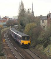 A Hazel Grove to Blackpool North stopping service, formed by 150132/138, approaches the Blackpool Road bridge on a gloomy 22nd November 2016. This scene is about to change with the imminent electrification of the Blackpool route.<br><br>[Mark Bartlett 22/11/2016]