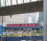 A train on the Docklands Light Railway calls at West India Quay in the summer of 2005 with a city bound service. The station stands on the north side of the old West India Docks, some 200m east of the site of the original London & Blackwall Railway West India Docks station, closed in 1926. <br><br>[John Furnevel /07/2005]