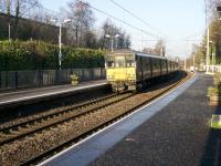 A 6 car 318 EMU on a Cumbernauld - Dalmuir service leaves platform 1 on a sunny January morning.<br><br>[Colin McDonald 27/01/2017]